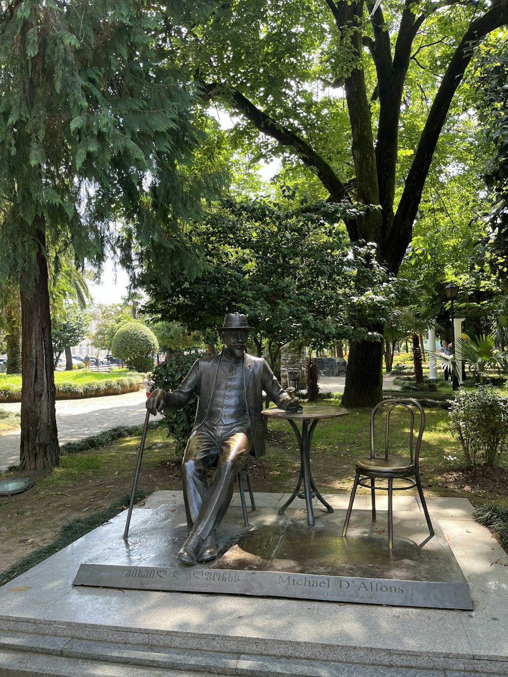 a statue of a man sitting at a table