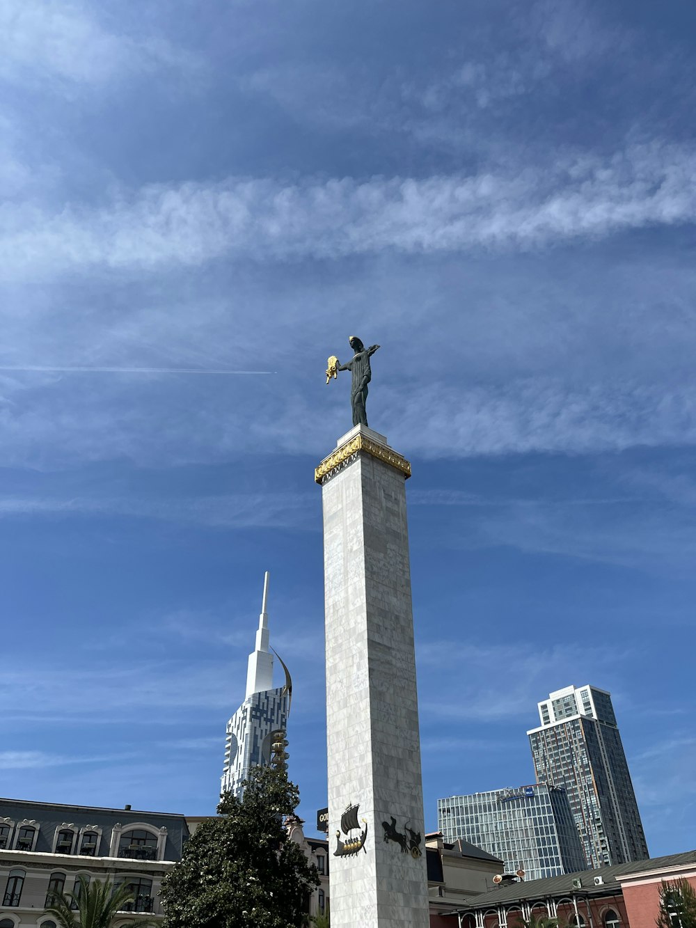 a monument with a statue of a man on top of it