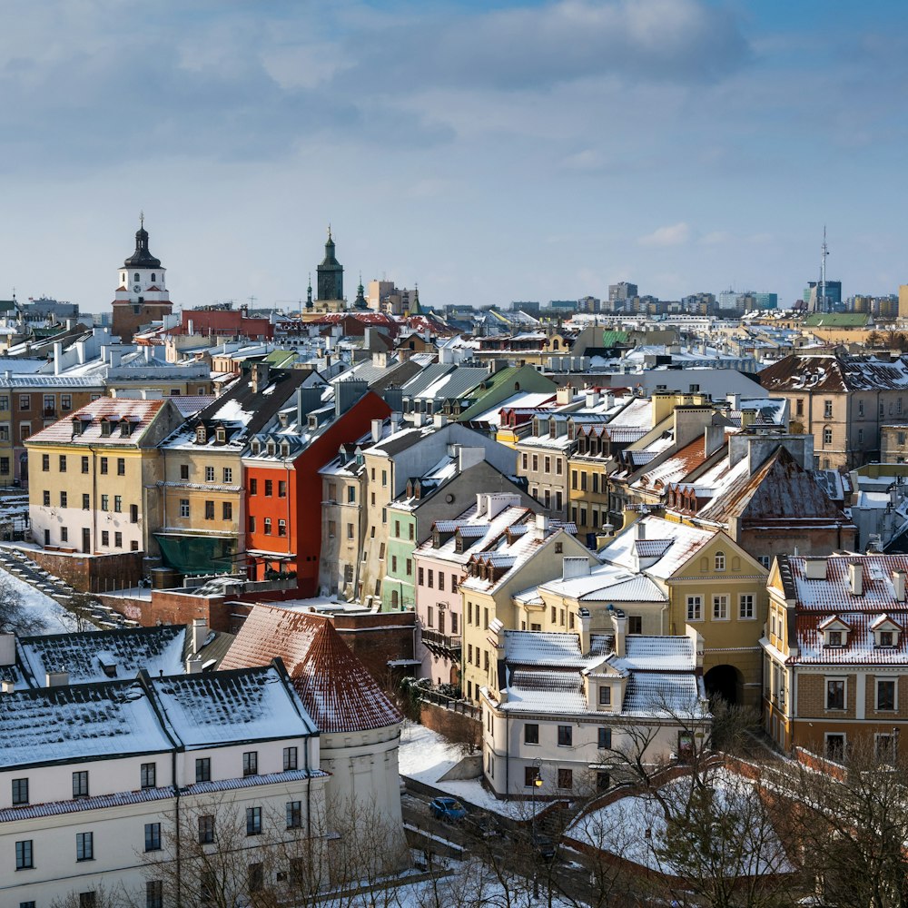 a view of a city with snow on the roofs