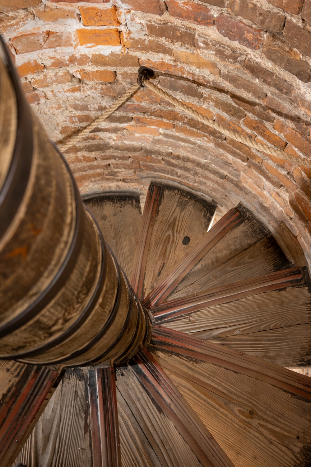 a spiral staircase in an old brick building