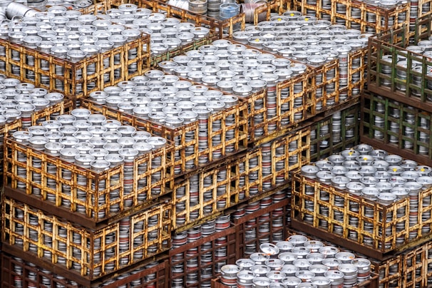Stacks of assorted beer cases ready for delivery in a well-organized warehouse.