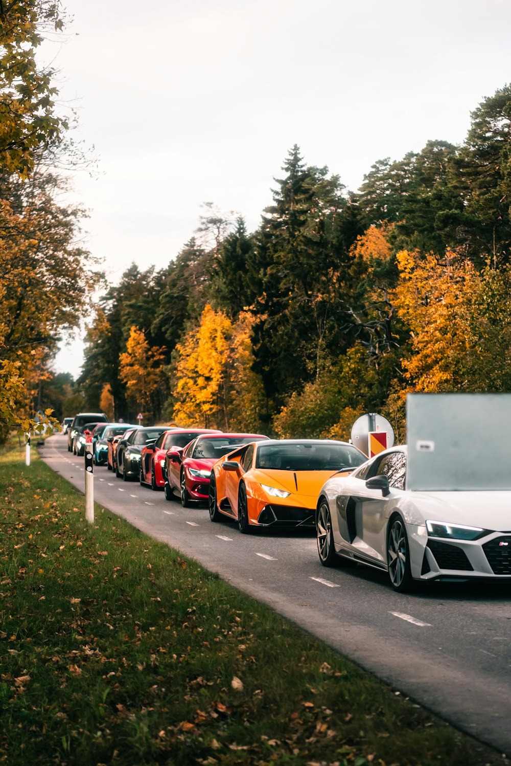 a line of cars parked on the side of a road
