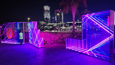 A nighttime cityscape with a model in Lumina’s reflective jacket glowing softly.