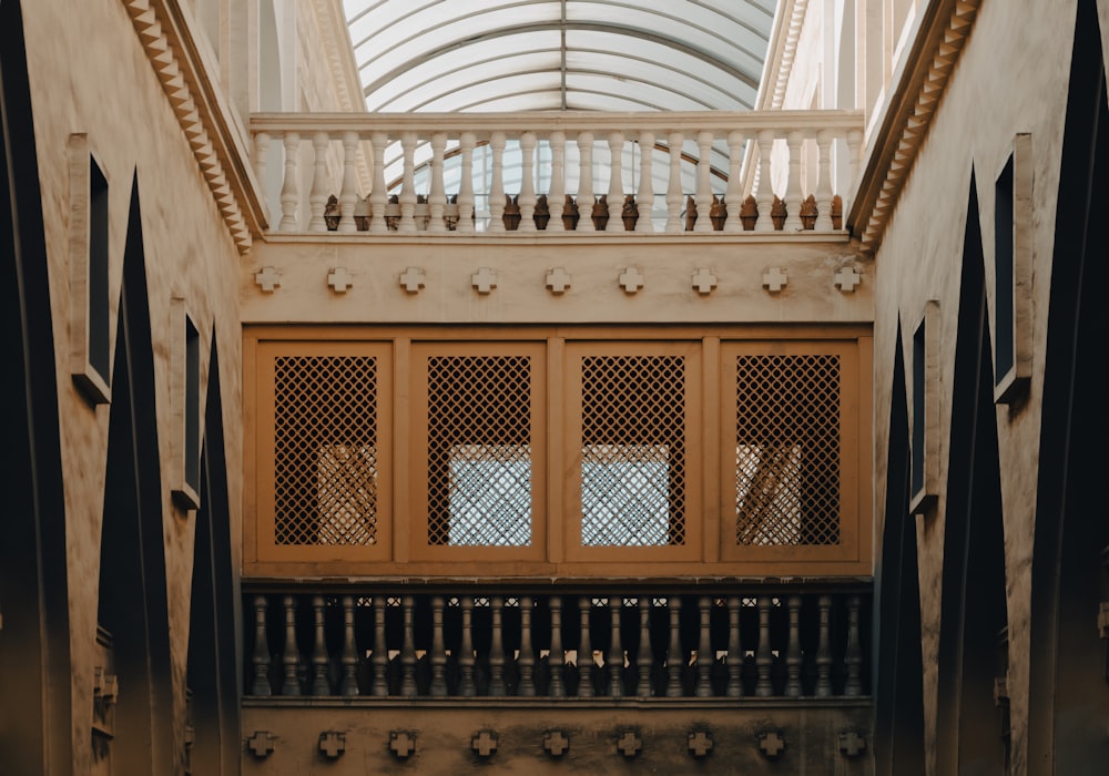 a building with a glass roof and wooden doors