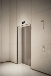 a white room with a silver door and a white wall