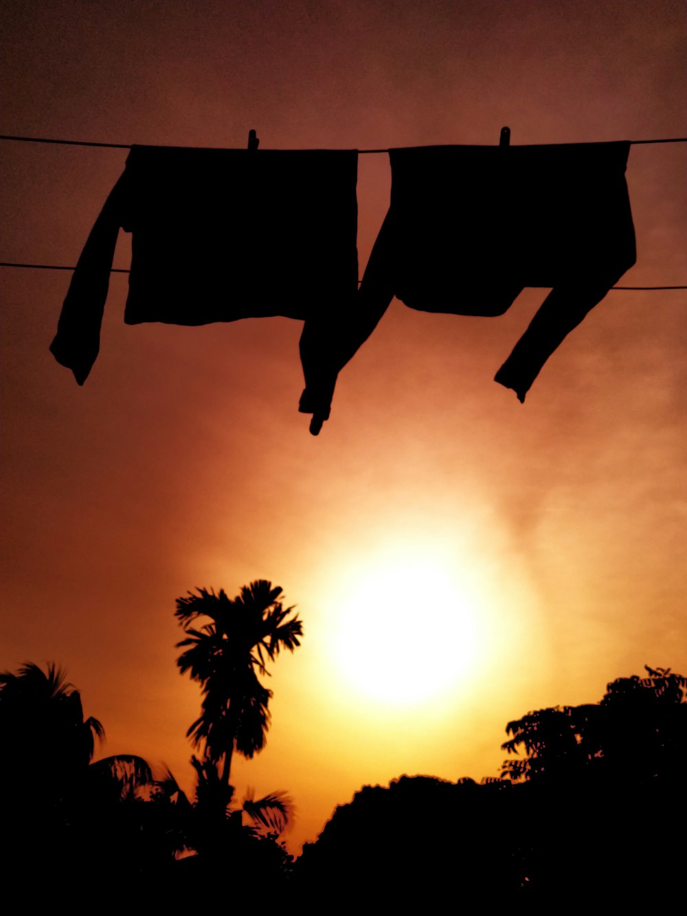 clothes hanging out to dry in front of the sun