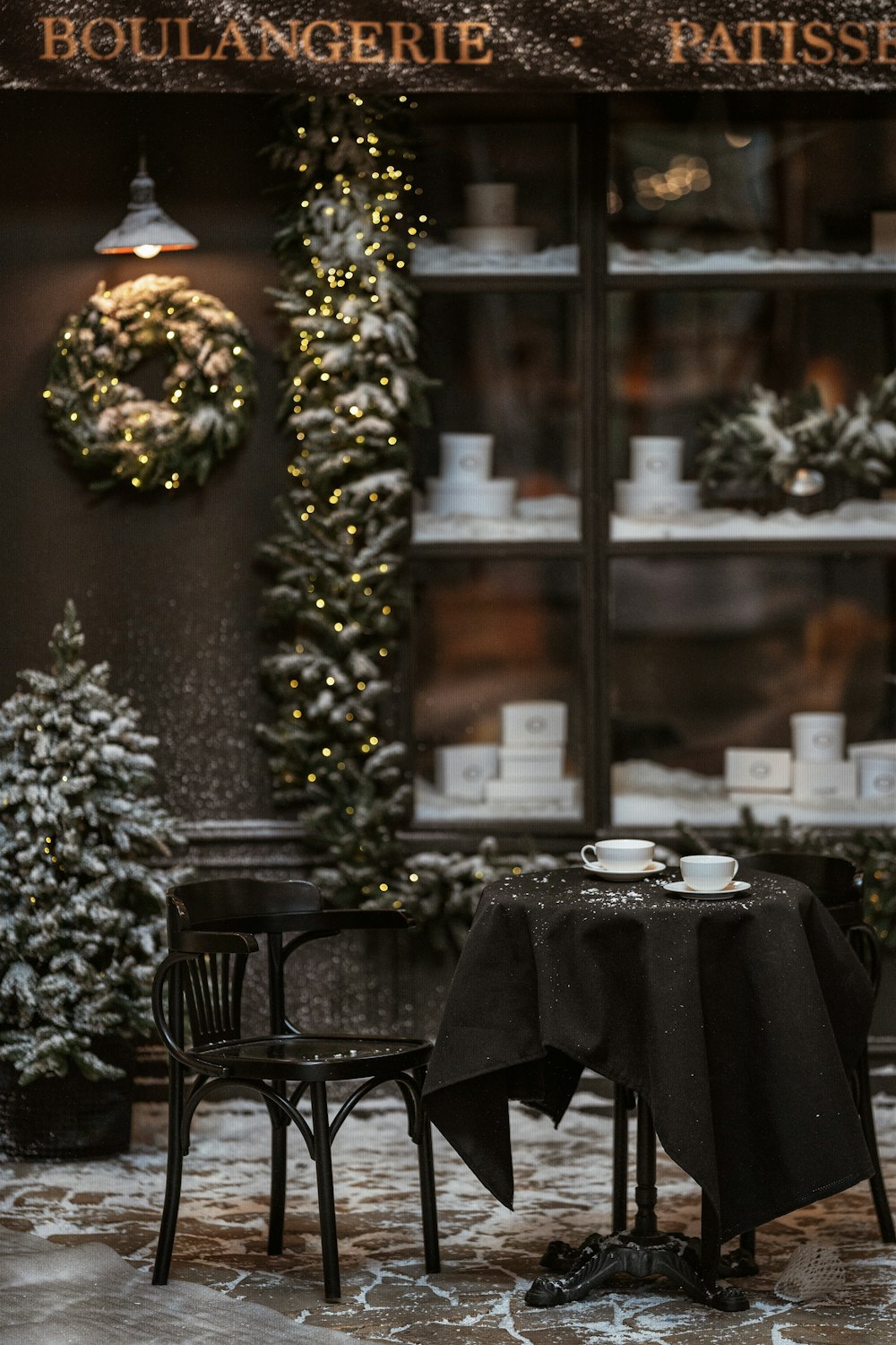 a couple of tables sitting in front of a store