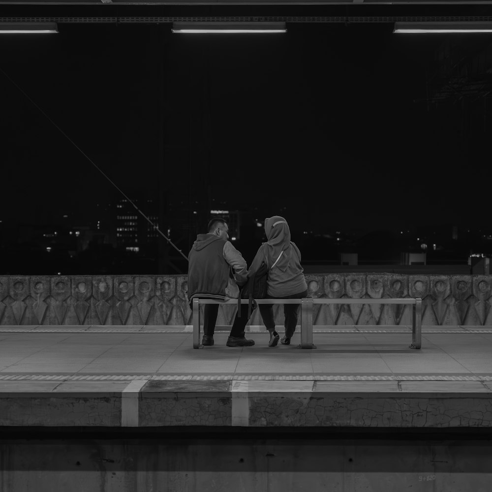 a couple of people sitting on a bench