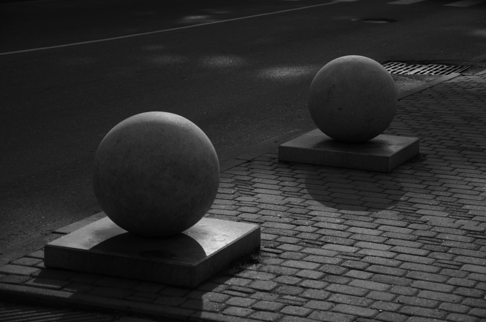 a couple of large balls sitting on top of cement blocks