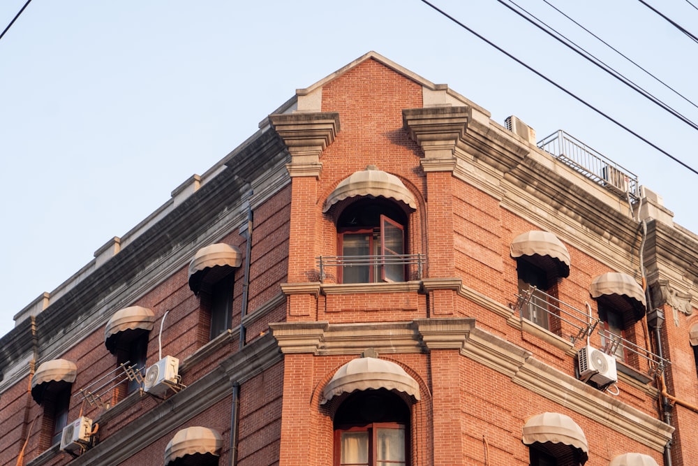 a red brick building with many windows and balconies