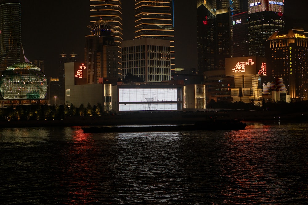 a large screen on the side of a large body of water