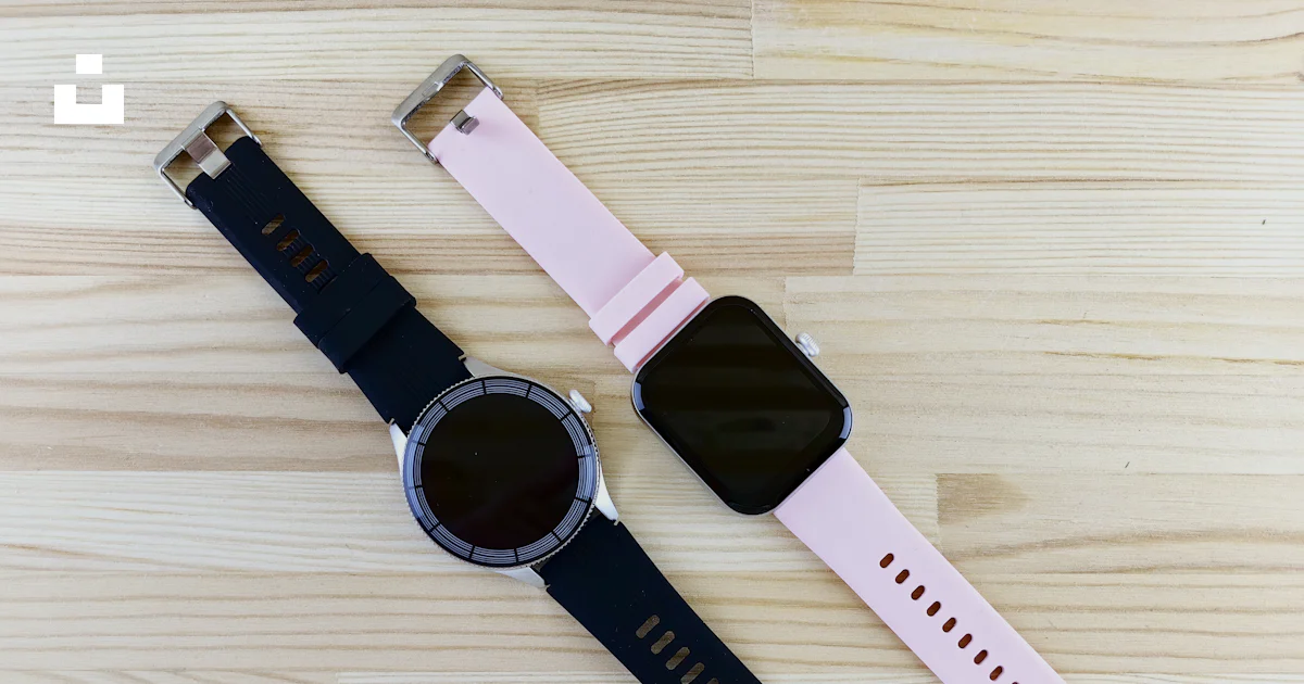Two Smartwatch Two smart watches sitting on top of a wooden table photo – Free Device ...