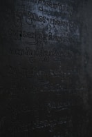 An ancient symbol etched into weathered stone, illuminated softly by morning light.