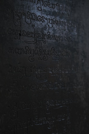 An ancient symbol etched into weathered stone, illuminated softly by morning light.