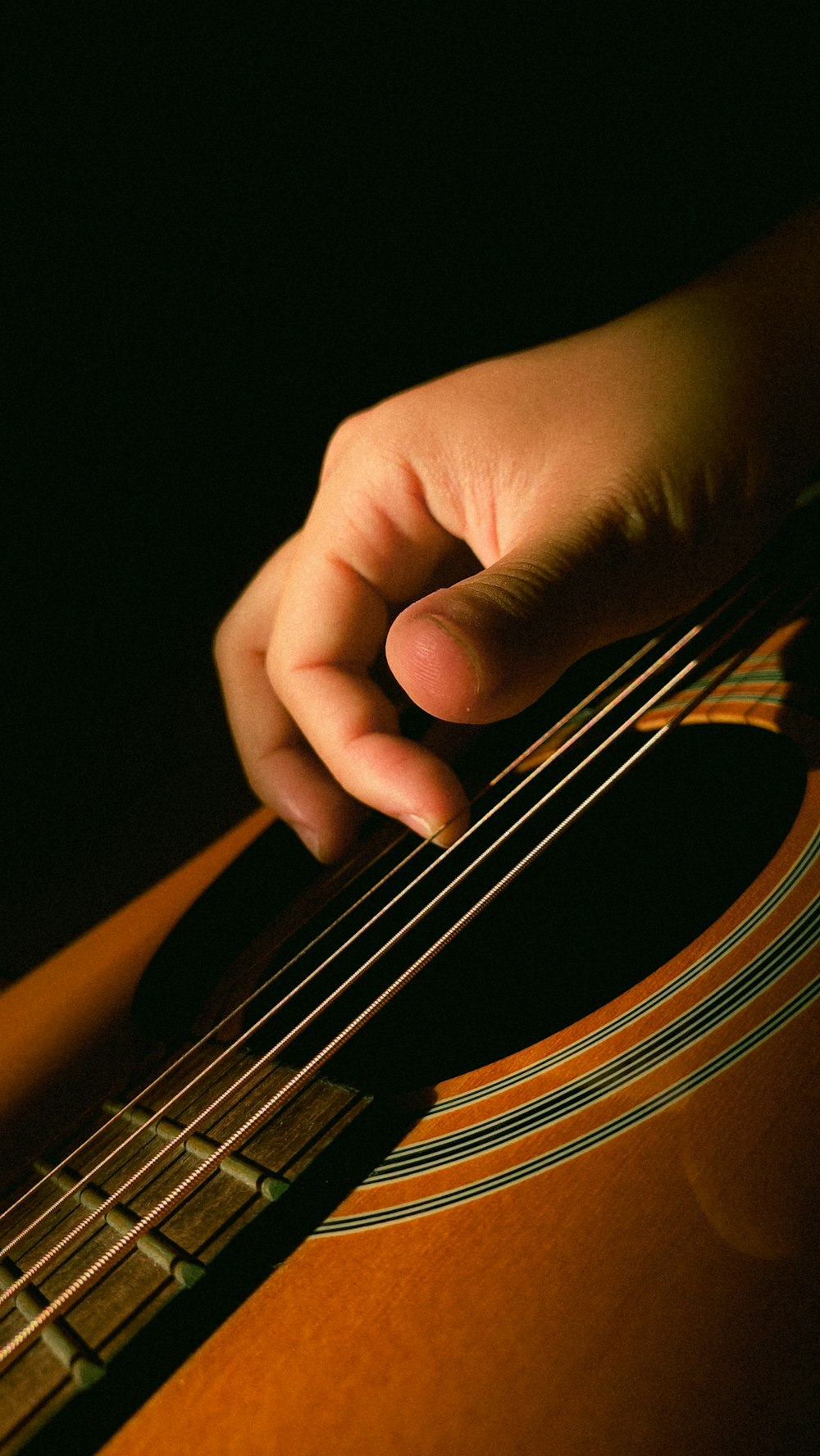a close up of a person playing a guitar