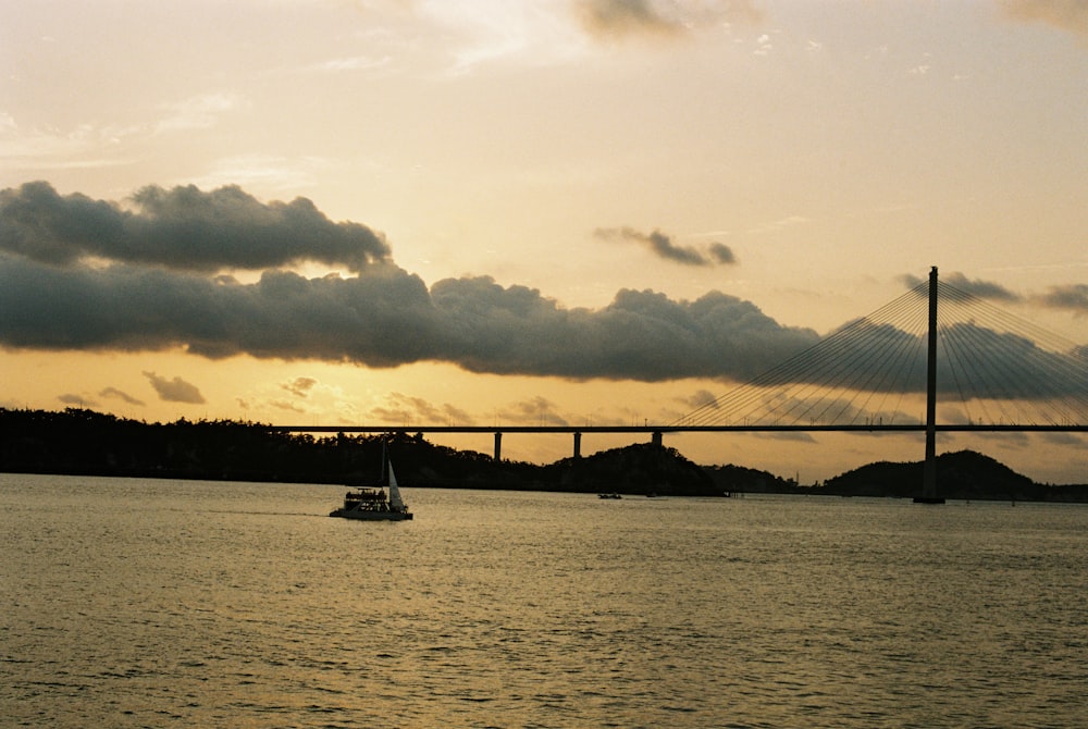 a boat is in the water near a bridge