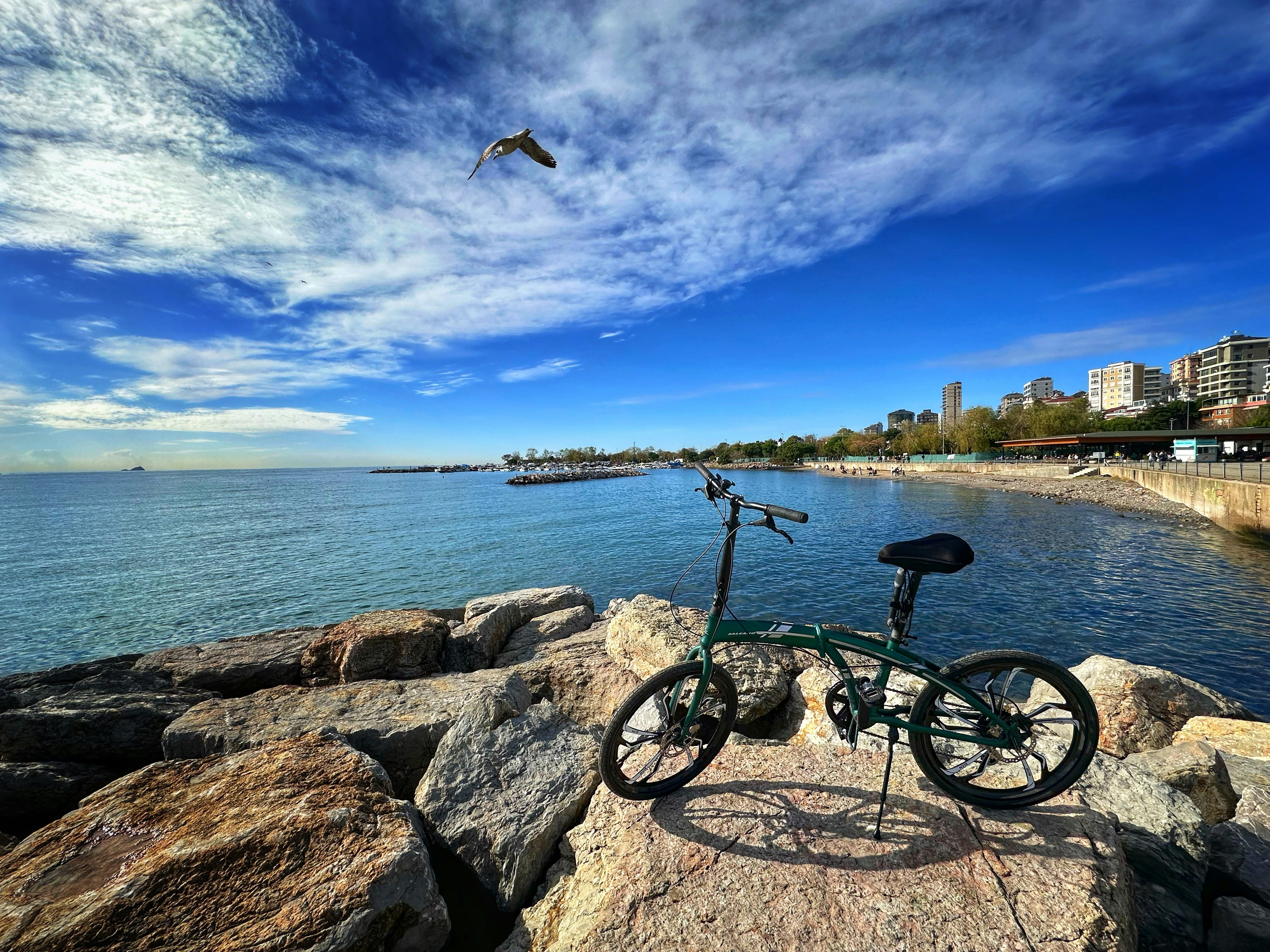 a bike is parked on a rock near the water