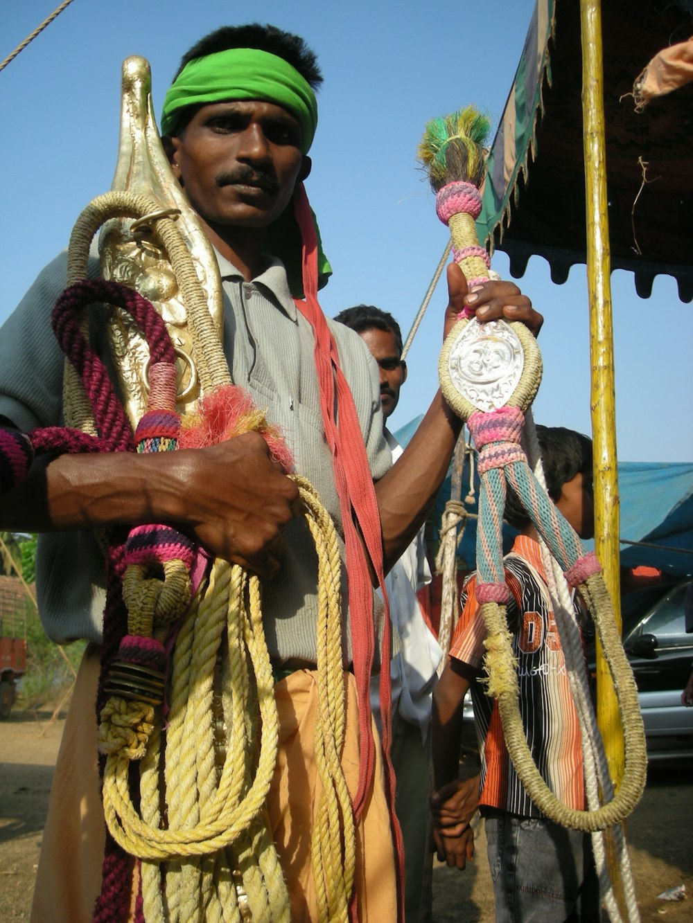 a man in a green headband holding a clock