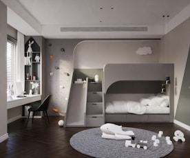 a child's bedroom with a bunk bed and toys on the floor