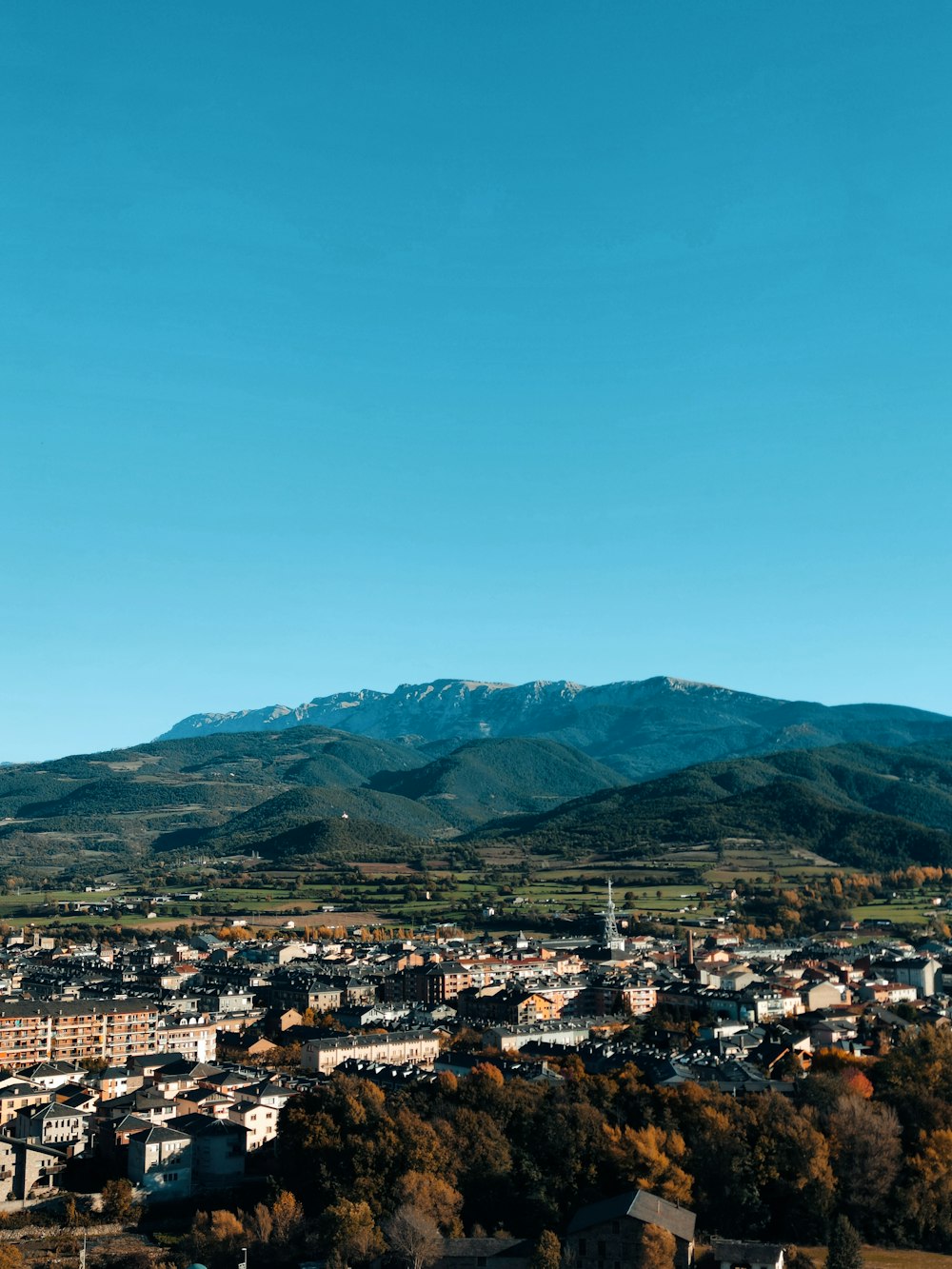 a view of a city with mountains in the background