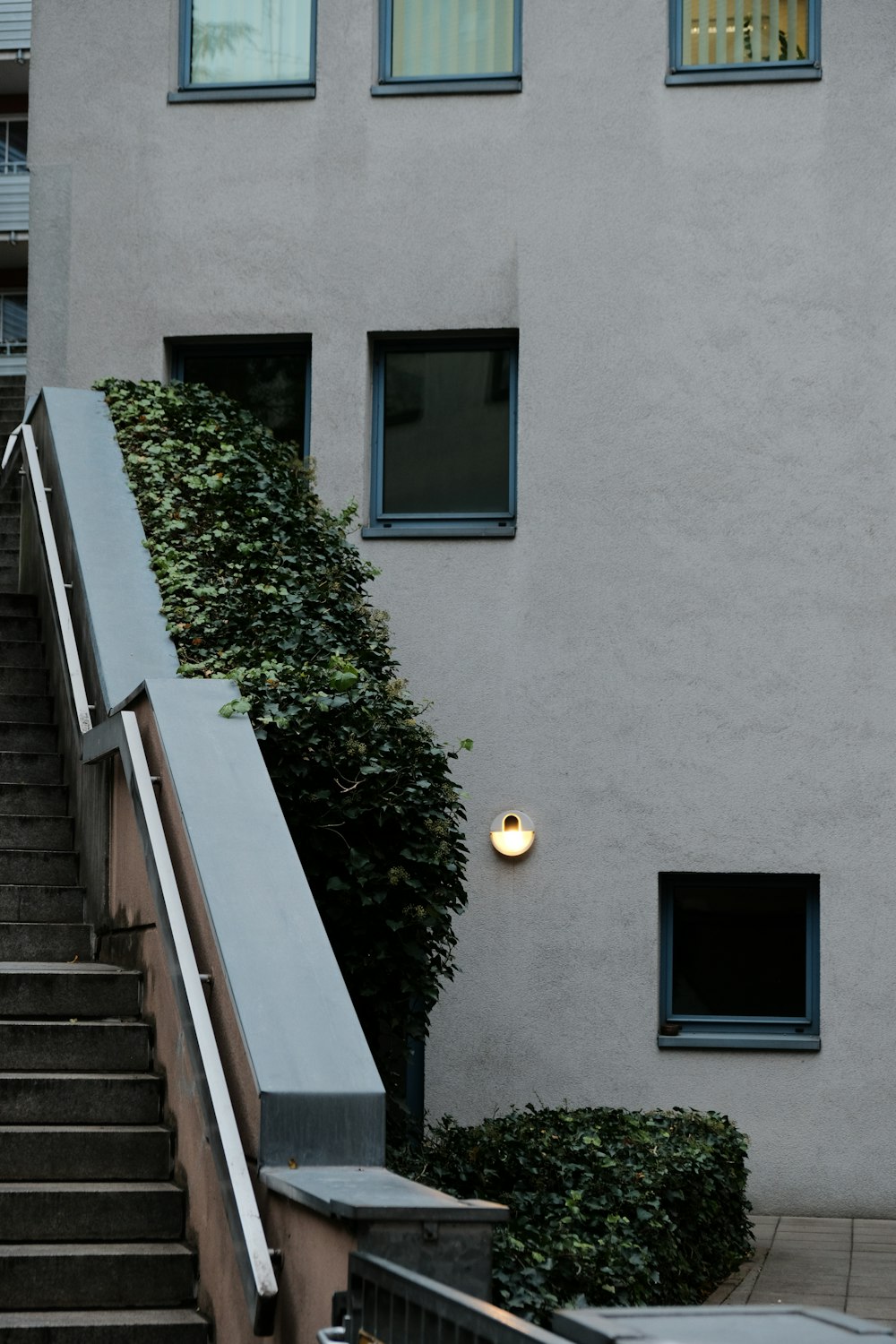 a stairway leading to a building with a light on