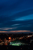 A wide shot of the Newcastle skyline at dusk, with players silhouetted in the foreground on an outdoor futsal court.