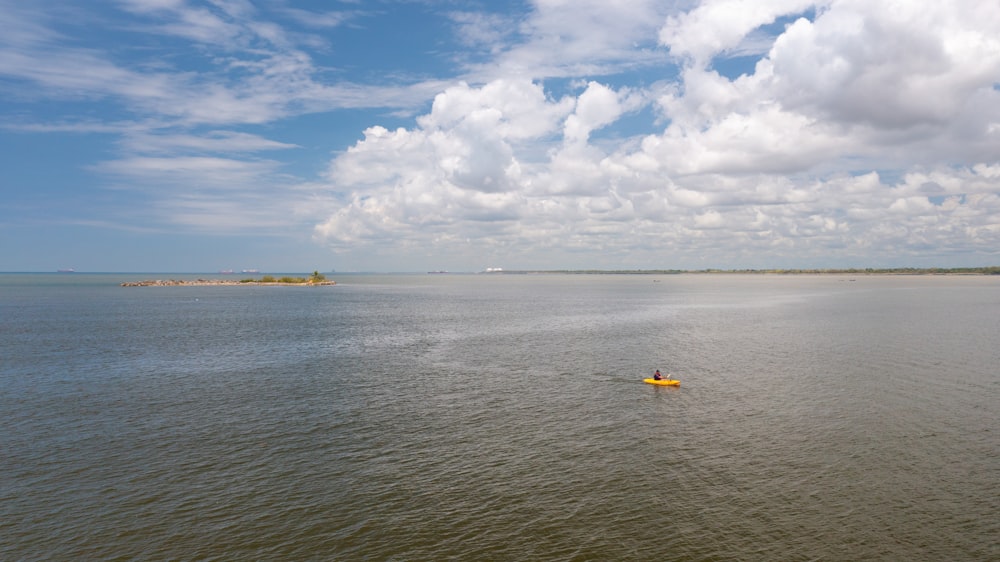 a person in a kayak in the middle of a lake