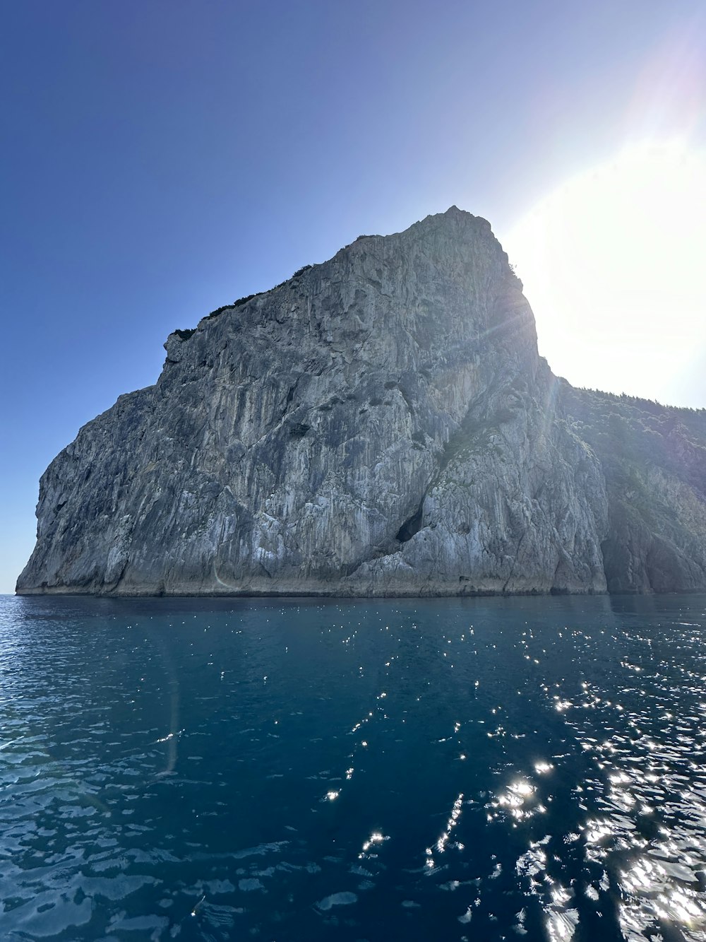 a large rock in the middle of the ocean