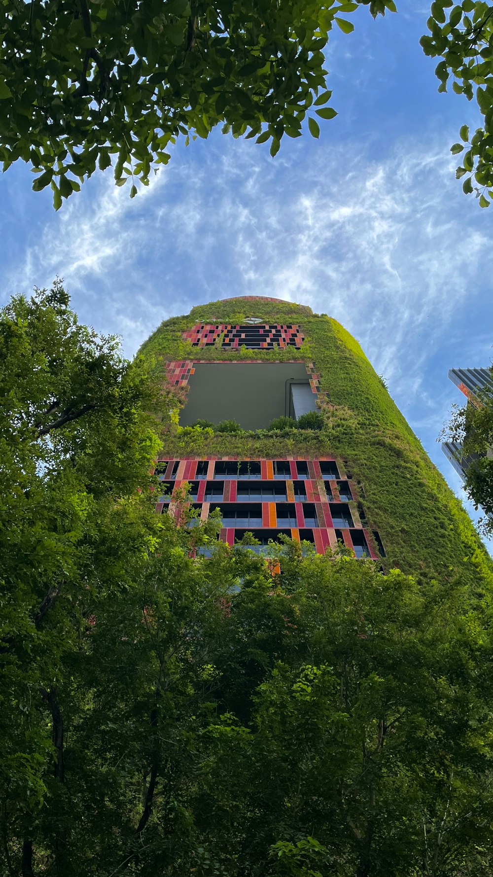 a very tall building with a green roof