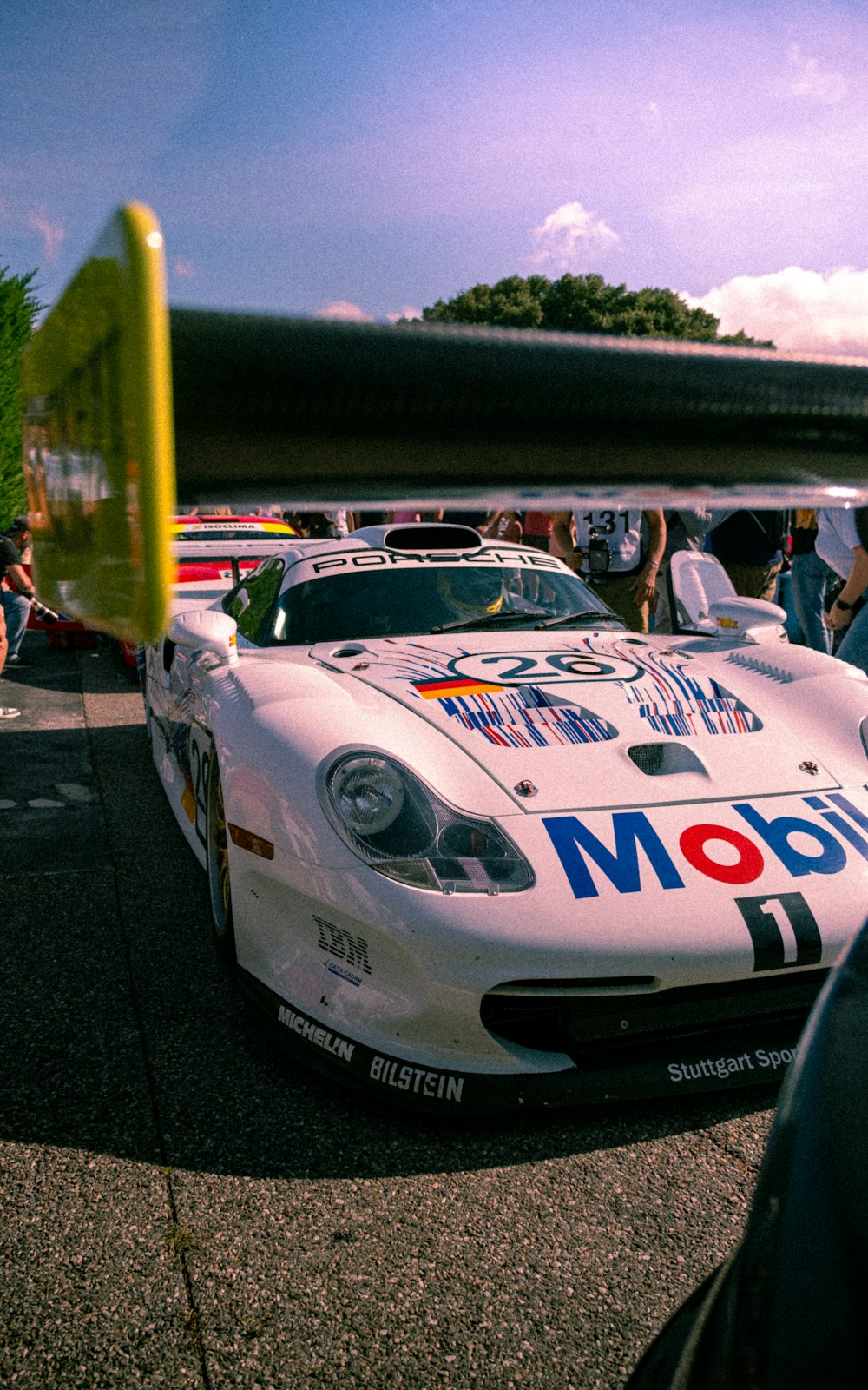 a white race car parked on the side of a road