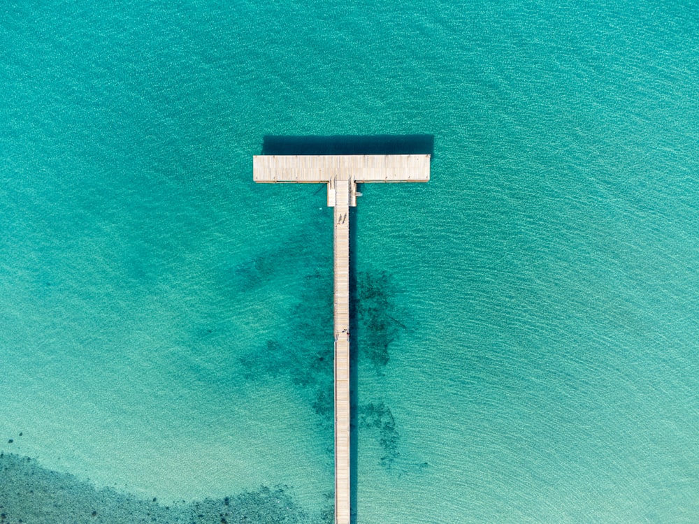 an aerial view of a beach with a sign in the middle of the water