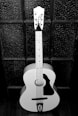 a black and white photo of a guitar