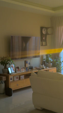 a living room filled with furniture and a flat screen tv