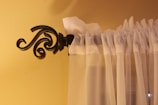 a curtain is hanging on the side of a window