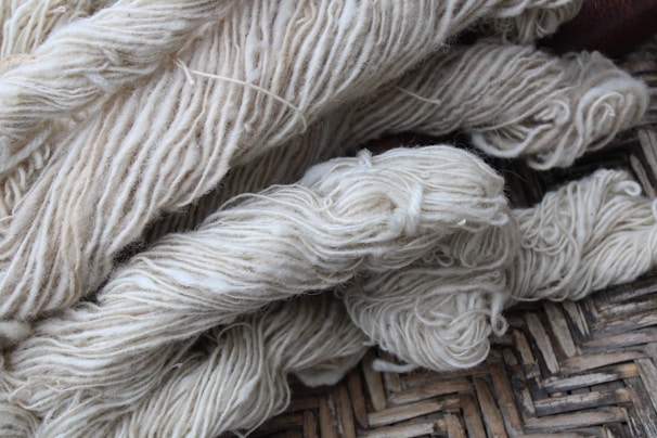 Bundles of eco-friendly cotton yarn ready for weaving, emphasizing sustainability.