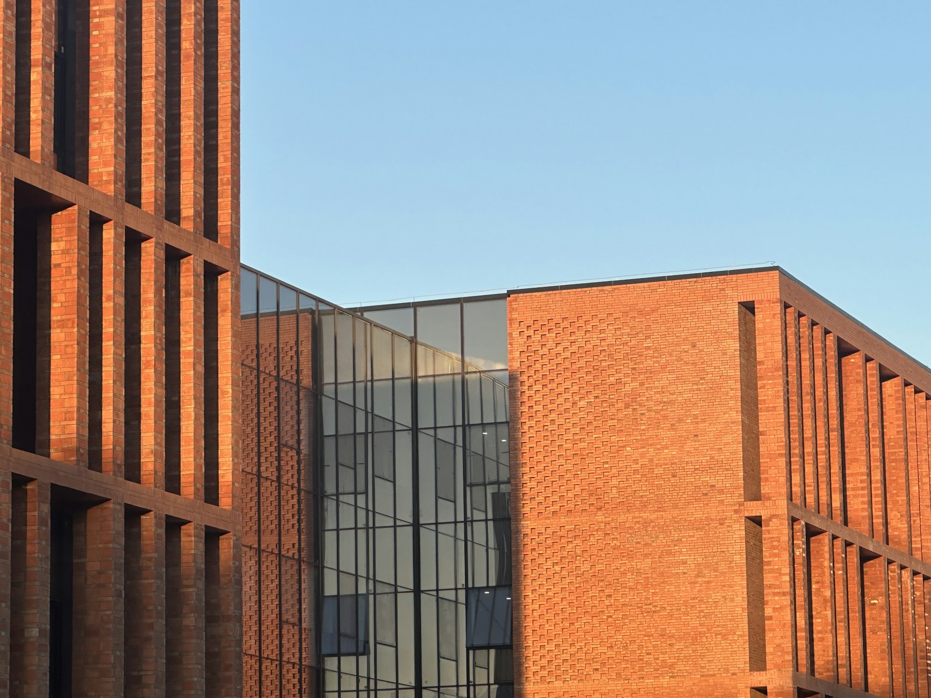 a tall brick building with a clock on it's side