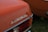 The rear end of a vintage car is featured with a close-up of the 'Automatic' emblem prominently displayed. The car is painted in a burnt orange color and the taillight assembly includes clear and red lenses. The setting appears to be an outdoor area with green grass visible.