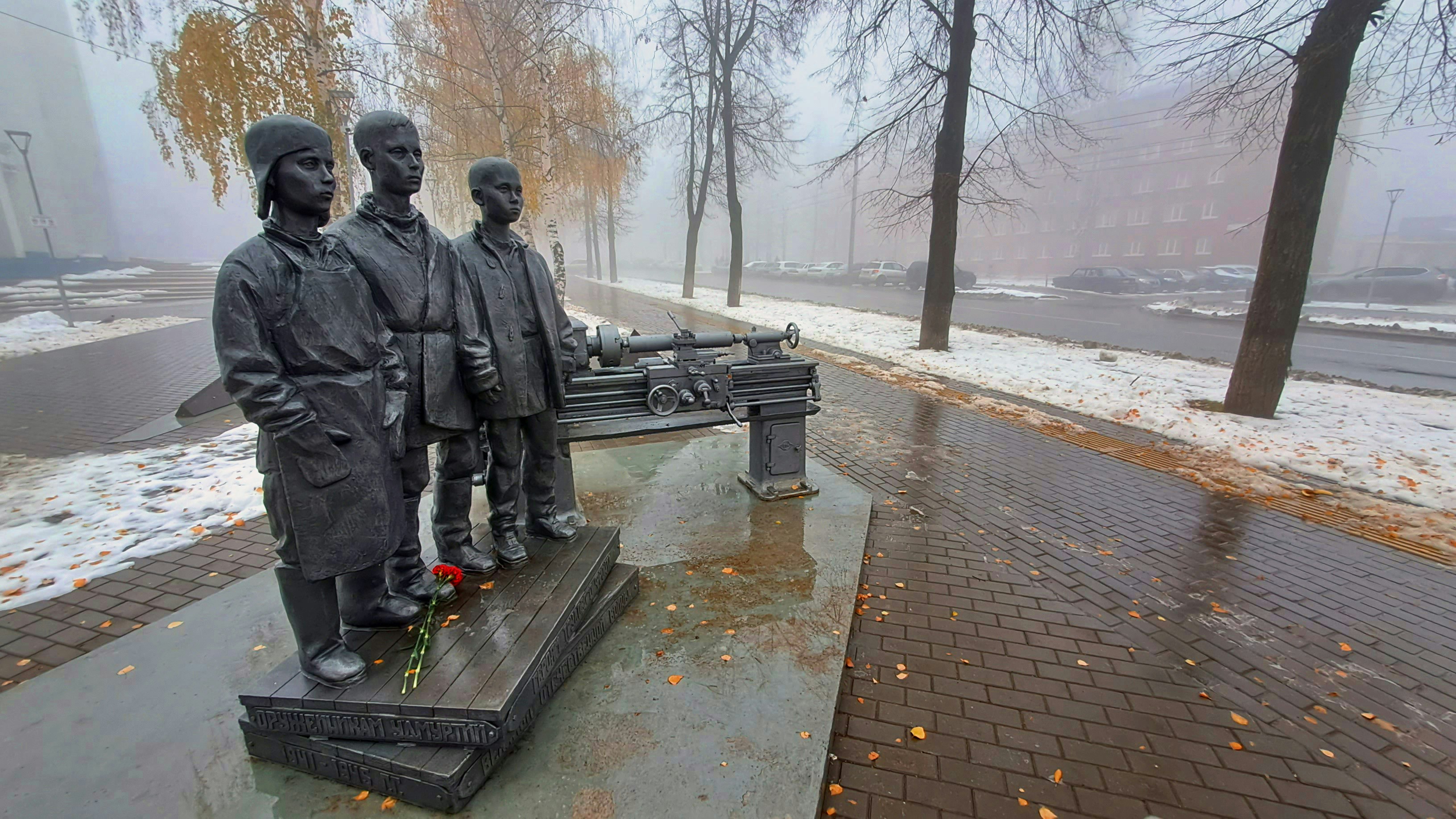 a couple of statues of people sitting on a bench