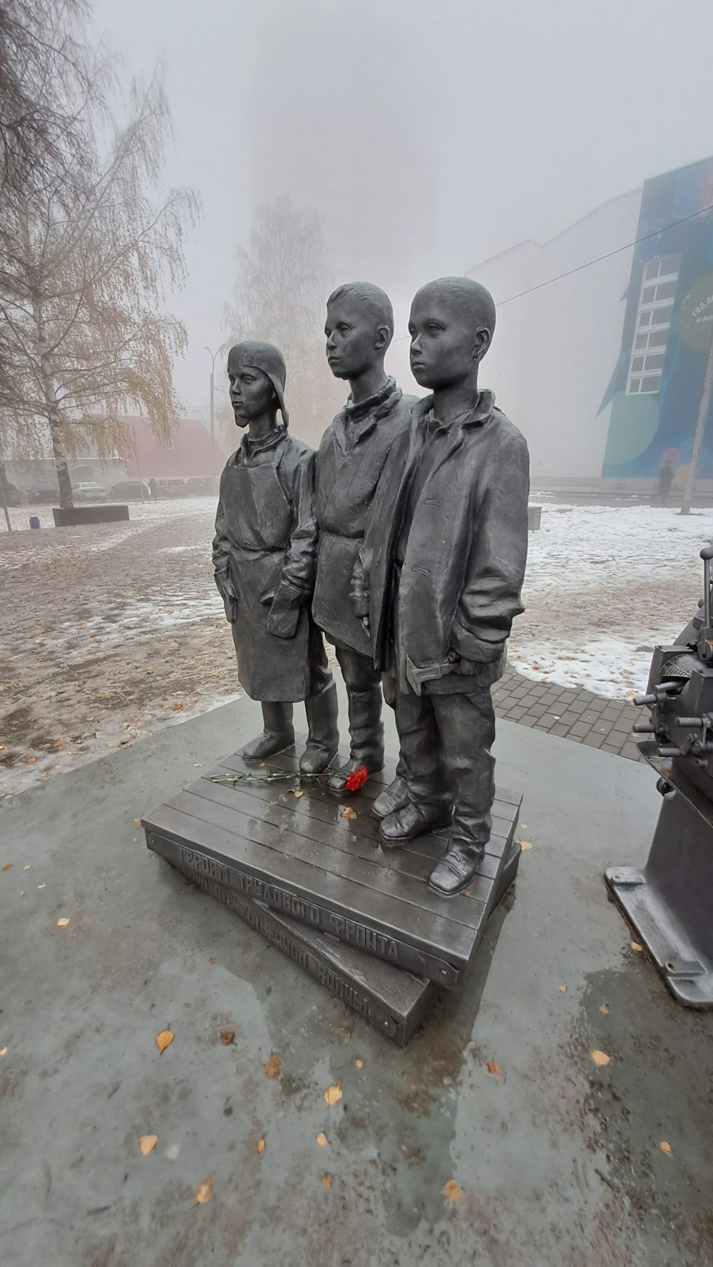 a statue of three children standing next to each other