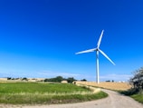 Wind turbine setup in a rural area with clear skies.