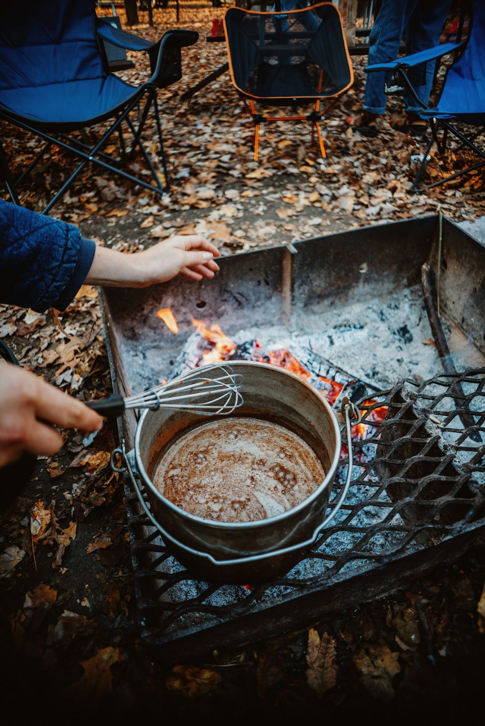 a person cooking food over an open fire