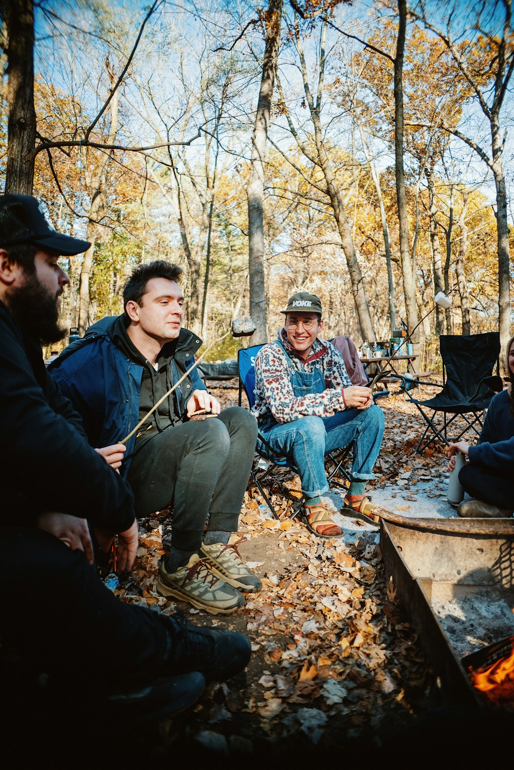 a group of people sitting around a campfire