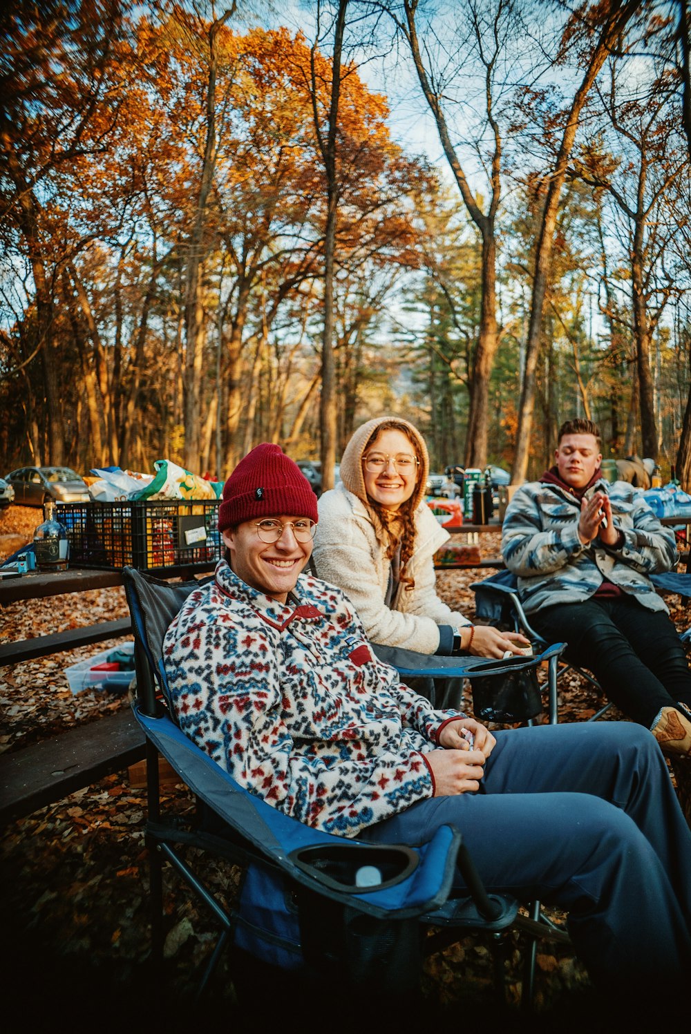 a group of people sitting in chairs in the woods