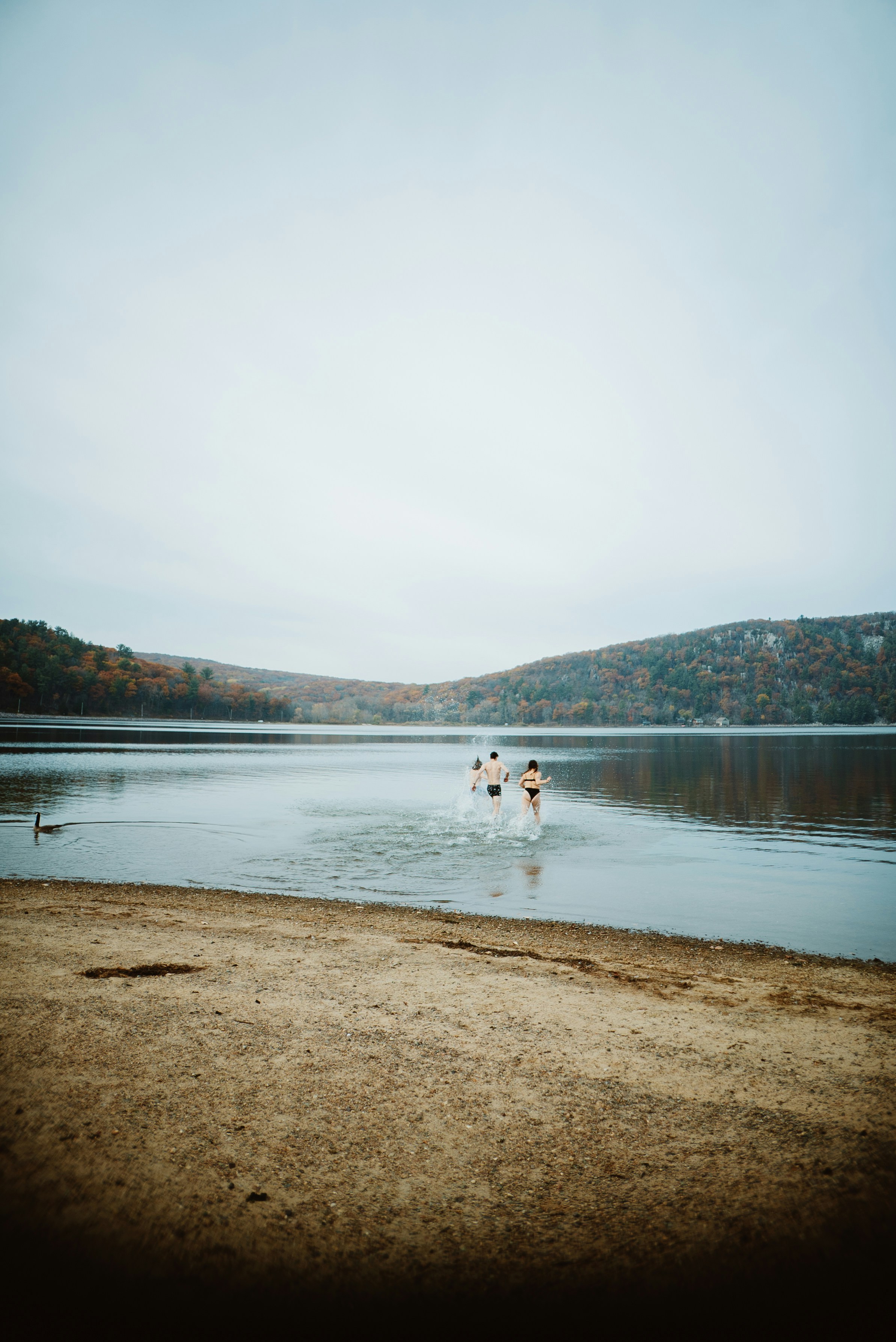 a group of people wading in a lake