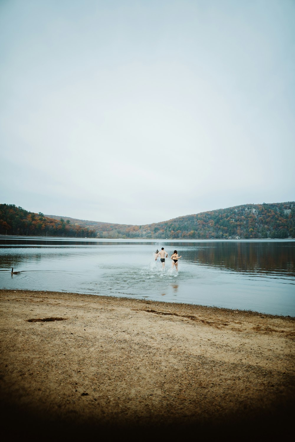 a group of people wading in a lake