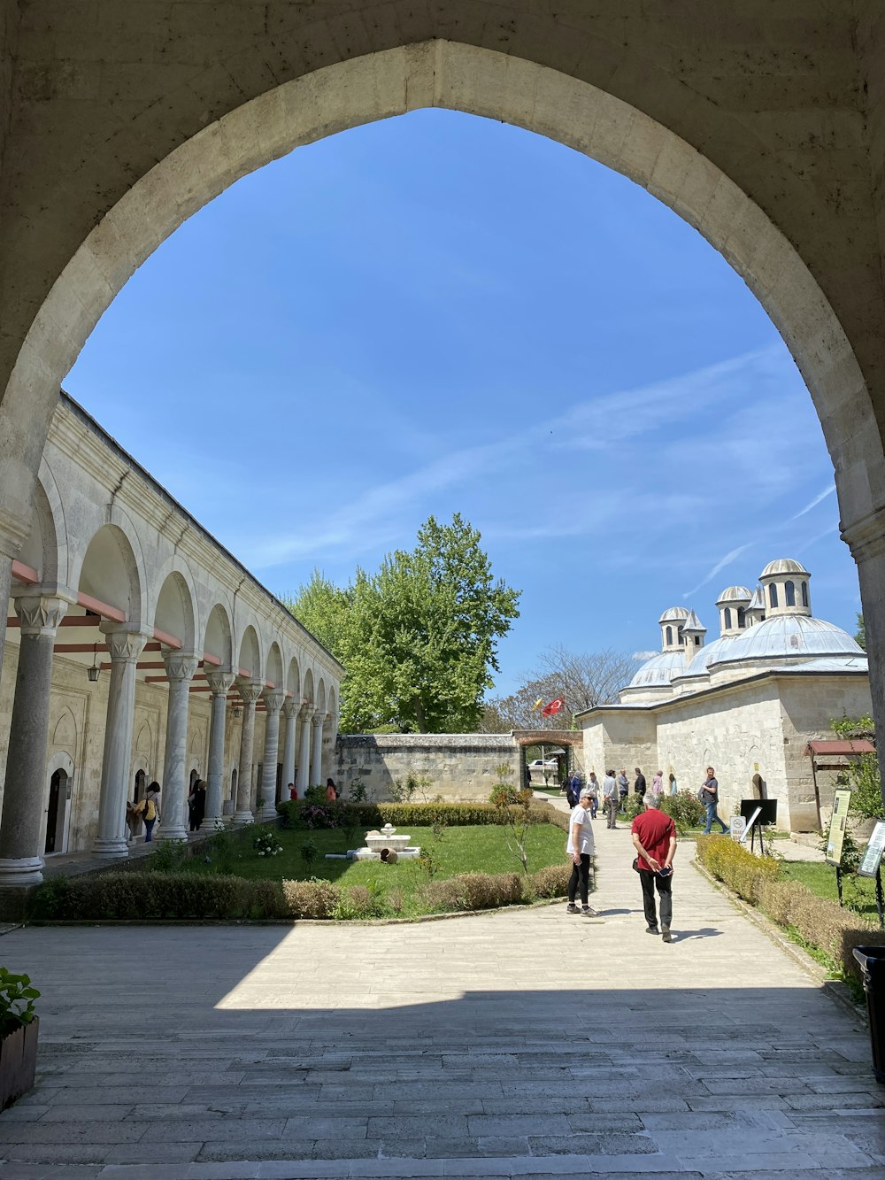 a couple of people that are walking under an arch