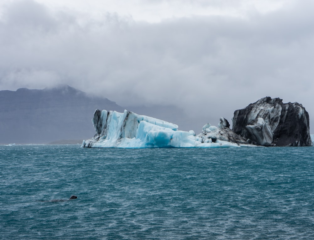 a large iceberg floating in the middle of the ocean