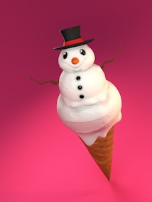 A whimsical snowman crafted from scoops of ice cream is perched atop a waffle cone. It features a traditional black top hat with a red band, a carrot-like orange nose, and buttons made from black items. Thin twig arms extend outward. The background is a vivid pink, enhancing the playful and surreal nature of the image.
