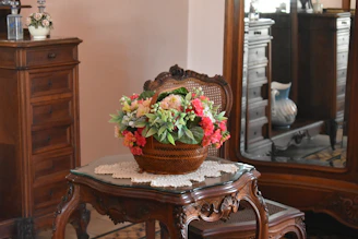 Handcrafted antique-style wooden dining table showcasing detailed floral carvings and a polished finish.