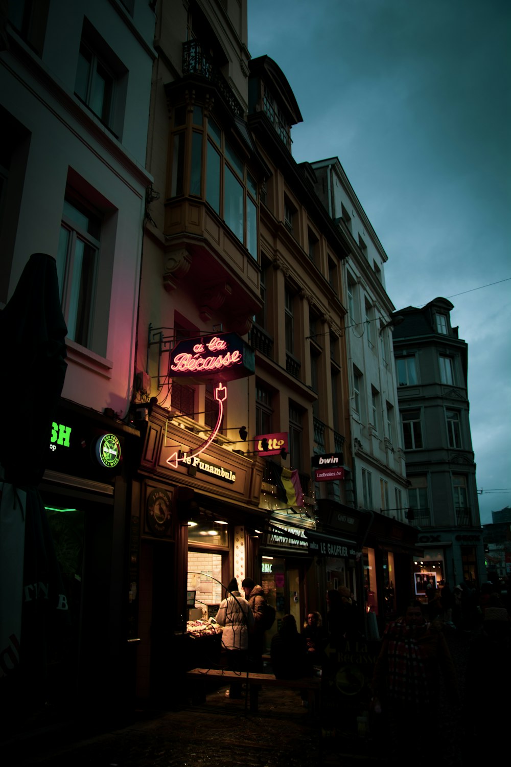 a building with a neon sign on the front of it